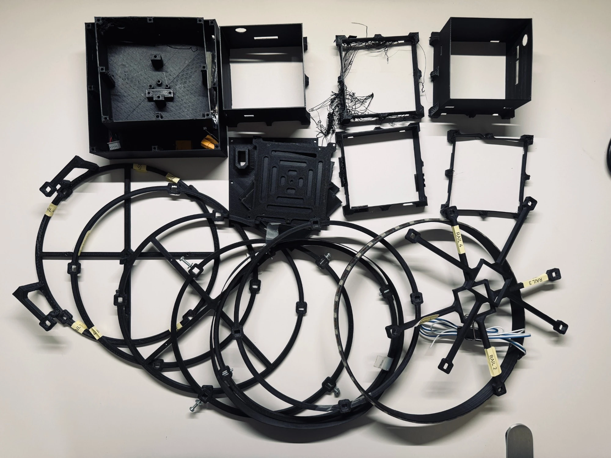 Retired AISHIP V3 parts: earlier and broken versions of the enclosure, frame rings and mounts